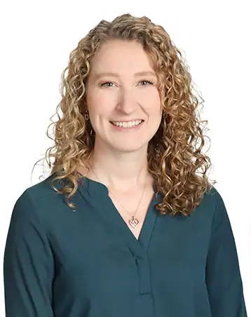 Supportive woman smiling, promoting The Center for Children with Special Needs.