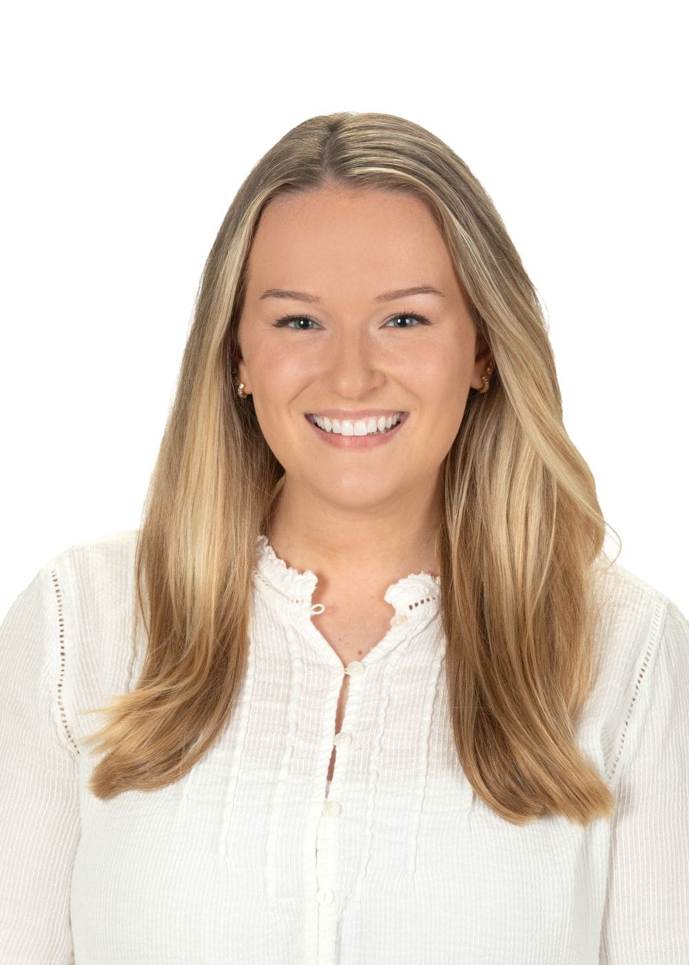 Smiling young woman with long blonde hair in a white blouse.
